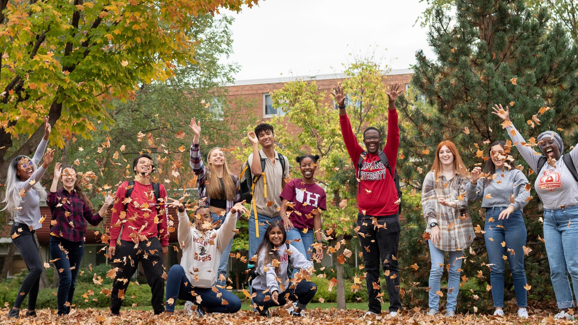  侫Ƶ happy students at 侫Ƶ during the fall blowing the leafs